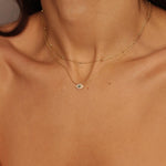 A satellite choker necklace in 18k gold plated silver. The necklace features a dainty chain with evenly spaced small beads, resembling satellites. The beads are made of gold and delicately interlinked. The necklace sits snugly around the neck, creating a trendy and minimalist look