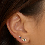 Evil eye stud earrings in 18k gold plated. The earrings feature a traditional evil eye design with a vibrant blue center. The evil eye symbol is believed to provide protection against negative energy and bring good luck. The studs are made of high-quality gold plated material with a polished finish, giving them a luxurious and elegant look.