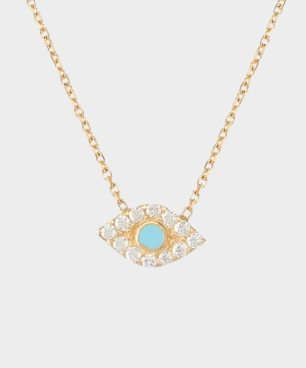 An evil eye charm necklace in 18k gold plated silver. The necklace features a delicate gold chain with an intricately designed evil eye charm pendant. The evil eye symbol is believed to provide protection against negative energies or ill-will, making this necklace both stylish and meaningful