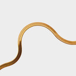 A herringbone flat chain in 18k gold plated. The chain features a distinct herringbone pattern with flat, interlocking links that create a sleek and polished appearance. The gold color adds a touch of luxury and elegance to the chain. The herringbone flat chain is a versatile accessory that can be worn on its own as a statement piece or layered with other necklaces for a stylish and trendy look. This chain is perfect for both casual and formal occasions, adding a touch of glamour to any outfit.