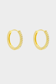 Diamond huggie hoops in 18k gold plated silver. The earrings feature a classic huggie-style design adorned with sparkling diamonds. The diamonds are meticulously set along the front of the hoops, adding a touch of luxury and glamour. The hoops are made of high-quality gold plated silver and have a polished finish.