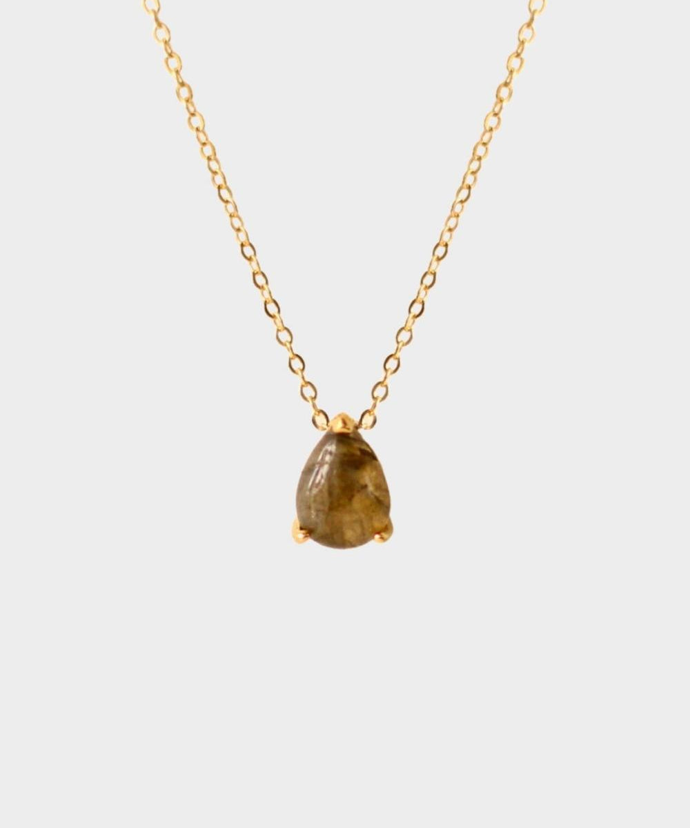 A labradorite stone pendant necklace in 18k gold plated silver. The necklace features a stunning labradorite stone pendant that is beautifully crafted and set in a gold bezel. The labradorite stone exhibits vibrant shades of grey with unique patterns, creating a captivating and natural look. The pendant is suspended from a delicate gold chain, adding elegance and sophistication to the necklace