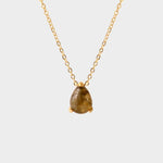 A labradorite stone pendant necklace in 18k gold plated silver. The necklace features a stunning labradorite stone pendant that is beautifully crafted and set in a gold bezel. The labradorite stone exhibits vibrant shades of grey with unique patterns, creating a captivating and natural look. The pendant is suspended from a delicate gold chain, adding elegance and sophistication to the necklace