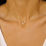 An initial pendant necklace in 18k gold plated silver. The necklace features a delicate gold chain, with a pendant in the shape of a single letter H from the alphabet. The pendant is intricately designed, showcasing the initial with a stylish and elegant font. Perfect for gifting or adding a personal touch to any outfit.