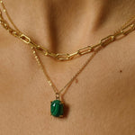 A malachite stone pendant necklace in 18k gold plated silver. The necklace features a stunning malachite stone pendant that is beautifully crafted and set in a gold bezel. The malachite stone exhibits vibrant shades of green with unique patterns, creating a captivating and natural look. The pendant is suspended from a delicate gold chain, adding elegance and sophistication to the necklace