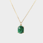 A malachite stone pendant necklace in 18k gold plated silver. The necklace features a stunning malachite stone pendant that is beautifully crafted and set in a gold bezel. The malachite stone exhibits vibrant shades of green with unique patterns, creating a captivating and natural look. The pendant is suspended from a delicate gold chain, adding elegance and sophistication to the necklace
