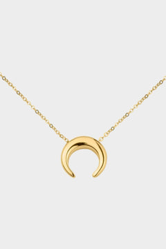 A moon necklace in 18k gold plated silver. The necklace features a delicate gold chain with a pendant in the shape of a crescent moon. The necklace is perfect for those who love celestial-inspired jewelry, and makes for an elegant and stylish accessory that can be worn on any occasion.