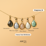 Set of five teardrop-shaped gemstone pendants on a beige background with AMIOA Jewels branding.