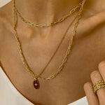 18k gold plated over sterling silver paper clip chain choker. The choker is composed of interlocking paper clip-shaped links, with each link carefully plated in 18k gold for a luxurious and radiant shine. The paper clip chain design gives the necklace a trendy and contemporary look. The choker is designed to sit comfortably around the neck, creating a stylish and fashionable accessory that can be worn alone or layered with other necklaces