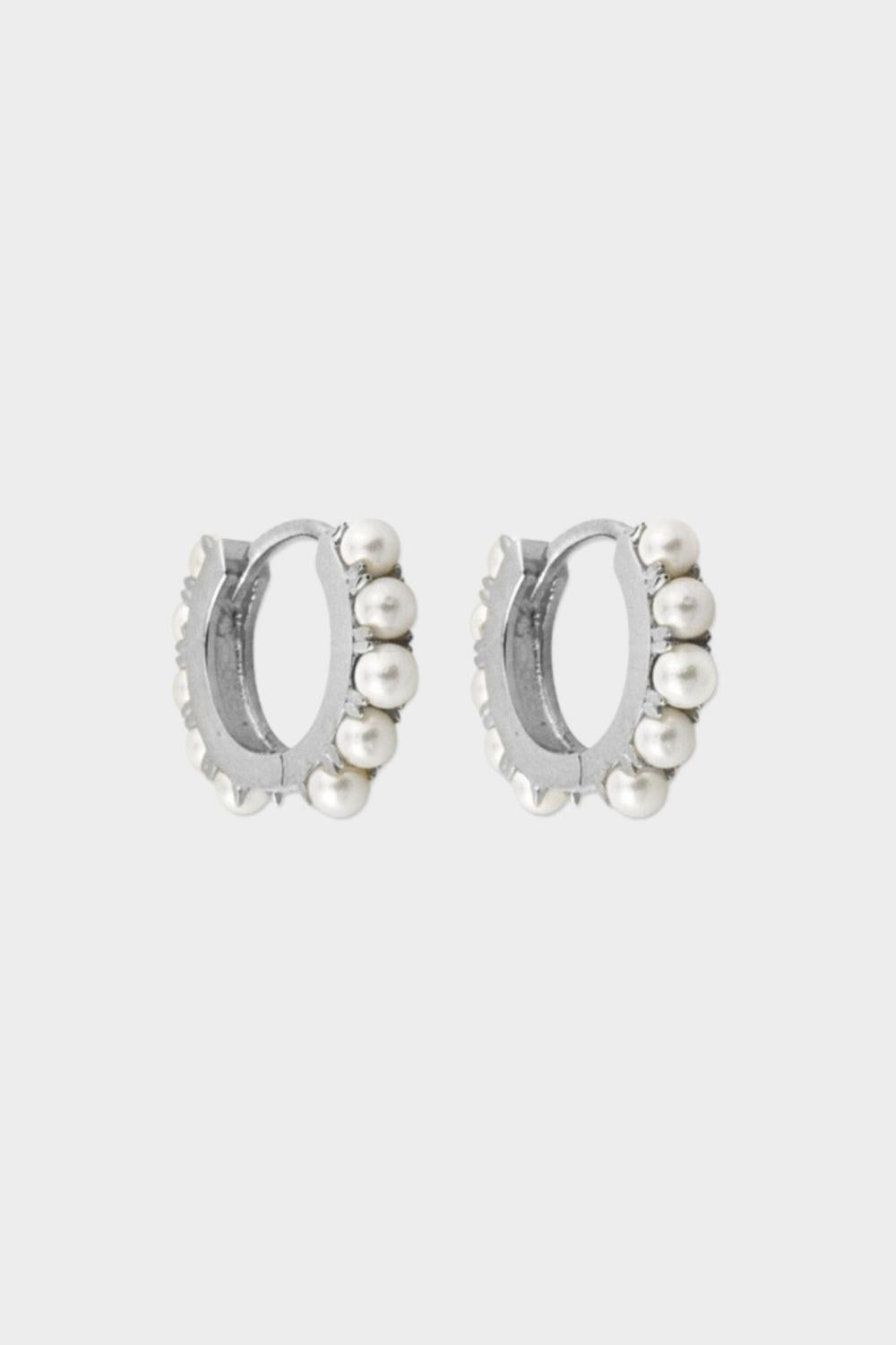 Beaded pearl huggies in sterling silver. The earrings feature a classic hoop design adorned with delicate beads and lustrous pearls. The gold plated silver adds a touch of elegance and sophistication to the design. The pearls are beautifully strung along the hoops, adding a timeless and glamorous element.