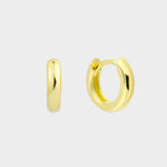  plain huggie hoops in 18k gold plated silver. The earrings feature a classic huggie-style design with a simple and sleek look. The hoops are made of high-quality gold plated silver and have a polished finish