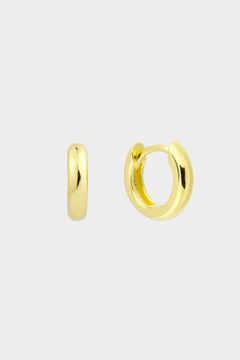  plain huggie hoops in 18k gold plated silver. The earrings feature a classic huggie-style design with a simple and sleek look. The hoops are made of high-quality gold plated silver and have a polished finish