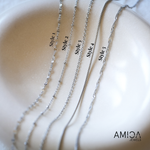 Five silver necklaces labeled Style 1 to Style 5 on a neutral background with AMICA JEWELS branding.