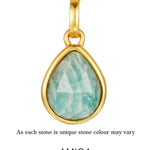 Gold pendant with a green teardrop-shaped gemstone on a white background, featuring the AMICA Jewels brand.