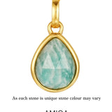 Gold pendant with a green teardrop-shaped gemstone on a white background, featuring the AMICA Jewels brand.