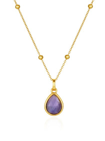 Gold necklace with a amethyst teardrop pendant on a white background
