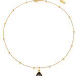 Gold necklace with a black teardrop pendant on a white background