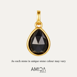 Gold pendant with a black teardrop-shaped gemstone on a light gray background, featuring the AMICA Jewels brand.