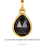 gold black onyx pendant agains white background