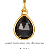 gold black onyx pendant agains white background