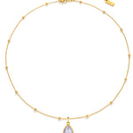 Gold necklace with a teardrop-shaped pendant on a white background