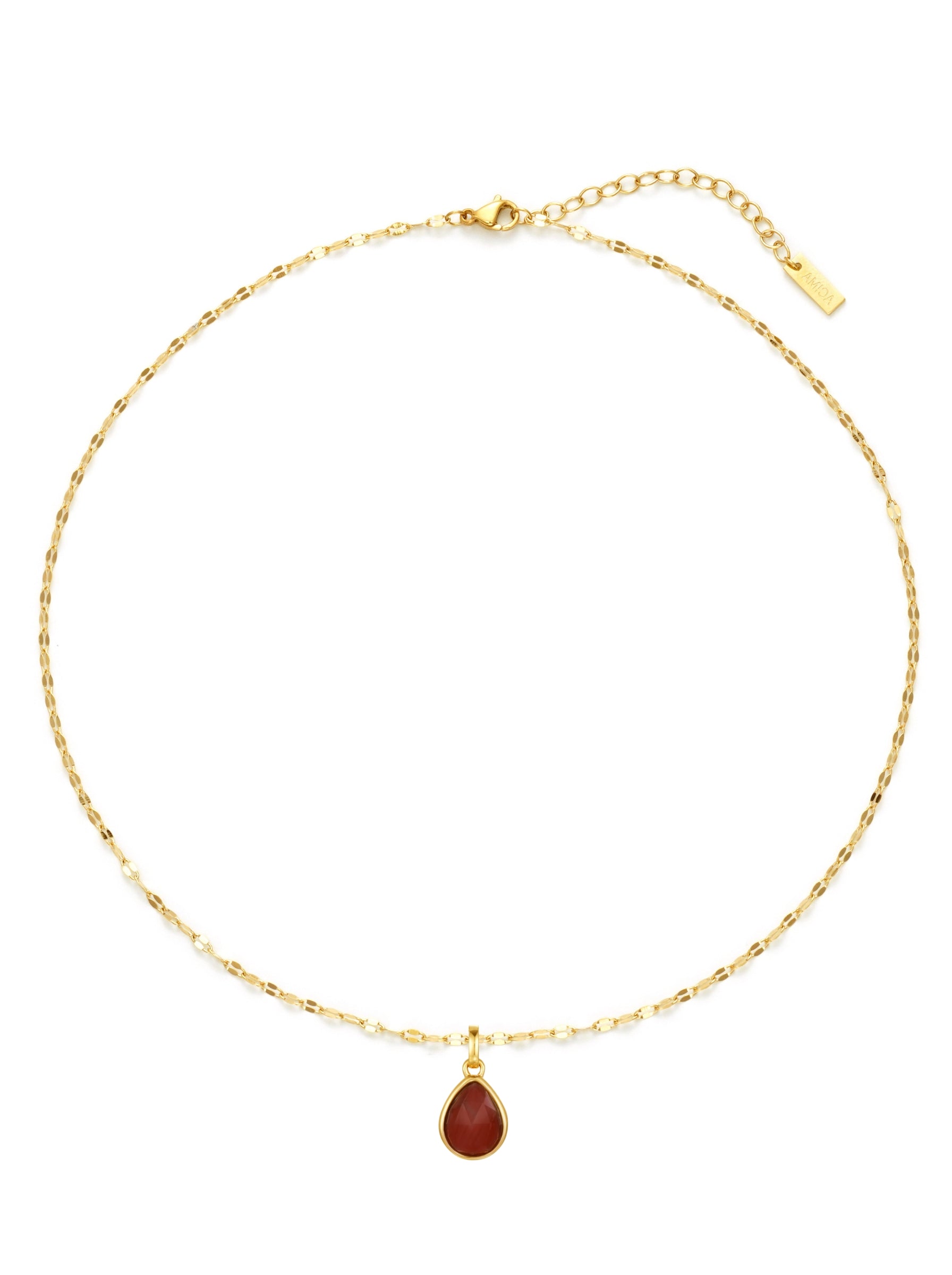 Gold necklace with a red teardrop pendant on a white background