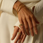 a 18k gold vermeil cuff bracelet with a round shape. The bracelet is made entirely of silver, with a smooth and polished finish. This versatile 18k gold vermeil cuff bracelet adds a touch of elegance and sophistication to any wrist.