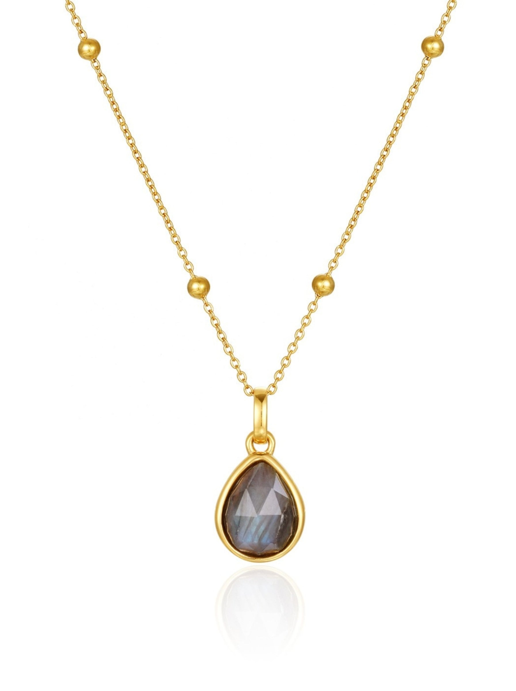 Gold necklace with a teardrop-shaped gemstone pendant on a white background