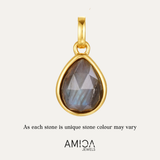 Gold pendant with a teardrop-shaped gemstone on a light gray background, featuring the AMICA Jewels brand.