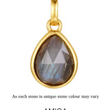 Gold pendant with a teardrop-shaped gemstone on a white background, featuring the AMICA Jewels brand.
