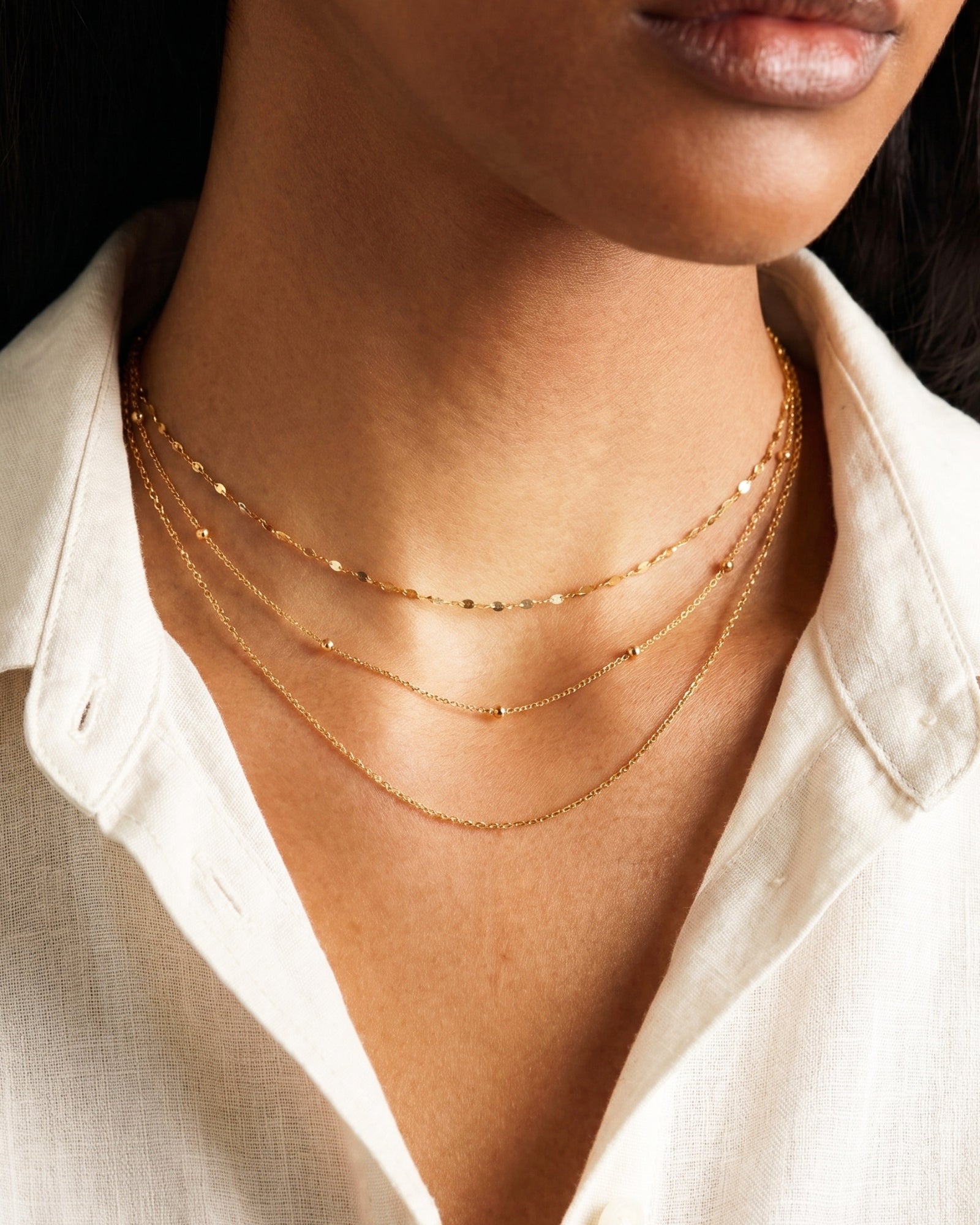 Layered gold satellite chain necklace styled with chain necklace – Amica Jewels