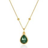 Gold necklace with a green malachite teardrop pendant on a white background