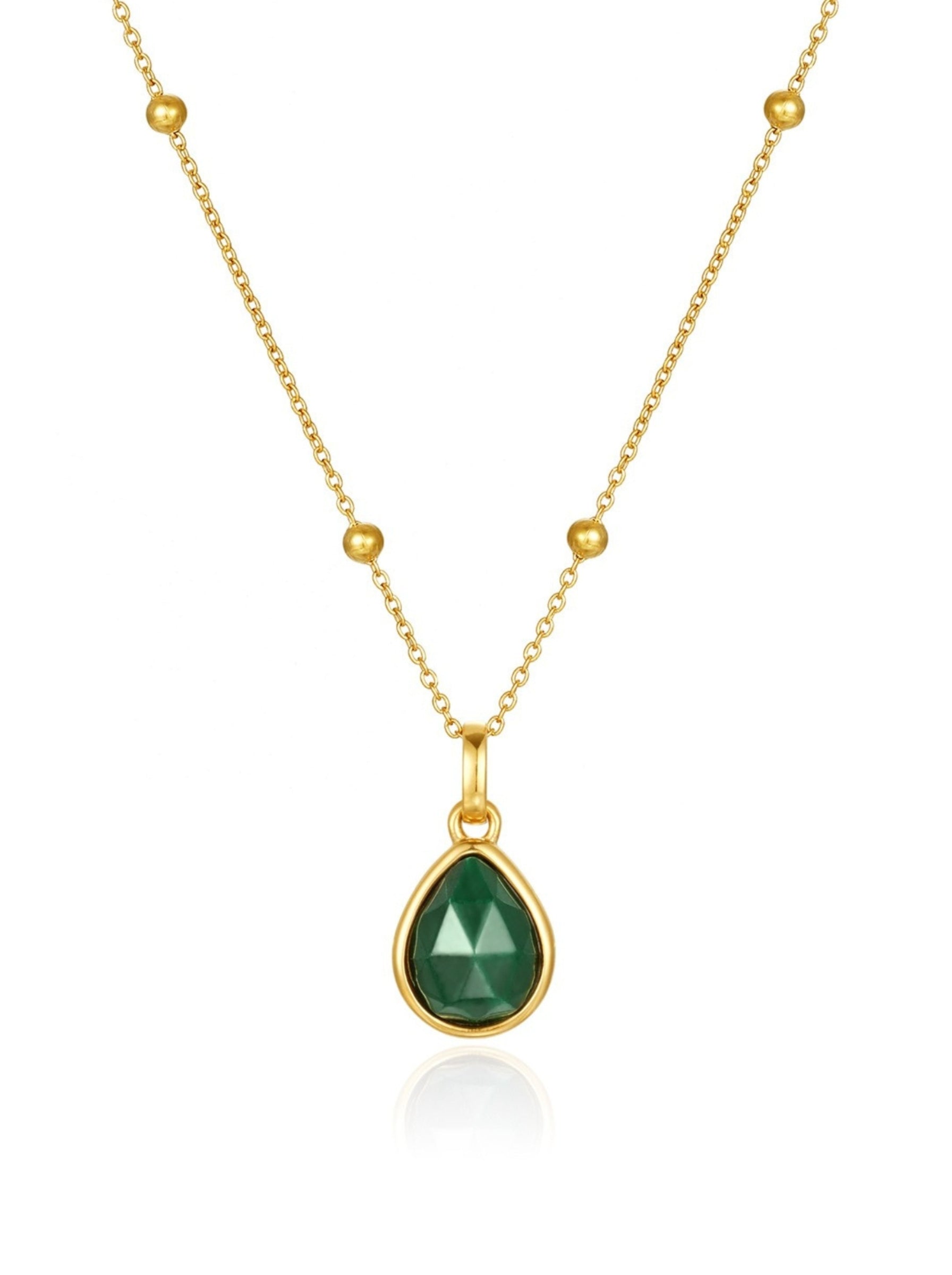Gold necklace with a green malachite teardrop pendant on a white background