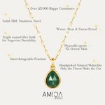 Gold necklace with green pendant on a white background, featuring AMIOA Jewels branding.