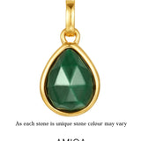 Gold pendant with a green teardrop-shaped gemstone on a white background, featuring the AMICA Jewels brand.