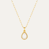 Gold necklace with a teardrop-shaped pendant on a light gray background