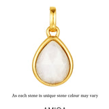Gold pendant with a white stone on a white background, featuring the AMIOA Jewels brand.