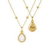 2 gold necklaces with moonstone pendants back and front on a white background
