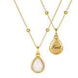 2 gold necklaces with moonstone pendants back and front on a white background