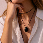 Model wearing a Black Obsidian pendant on a layered black silk cord