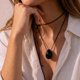 Model wearing a Black Obsidian pendant on a layered black silk cord