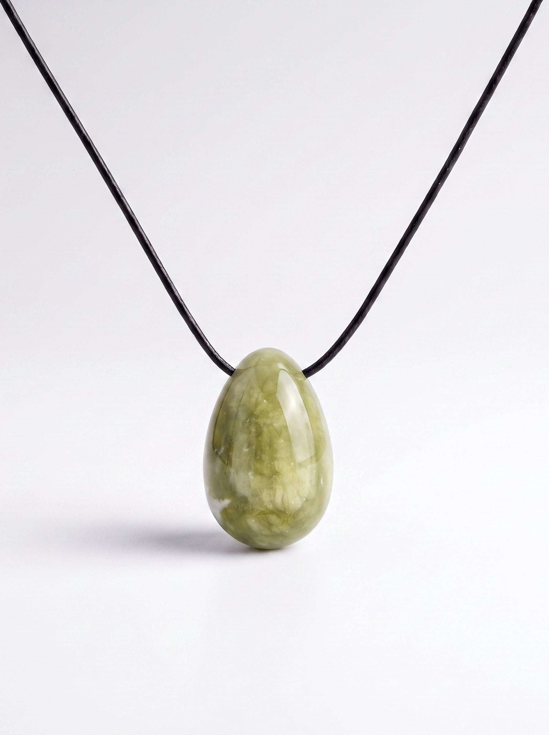 Light green Jade egg-shaped pendant necklace photographed on a white background