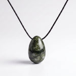 Dark green Southern Chinese Jade egg-shaped pendant on an adjustable black silk cord