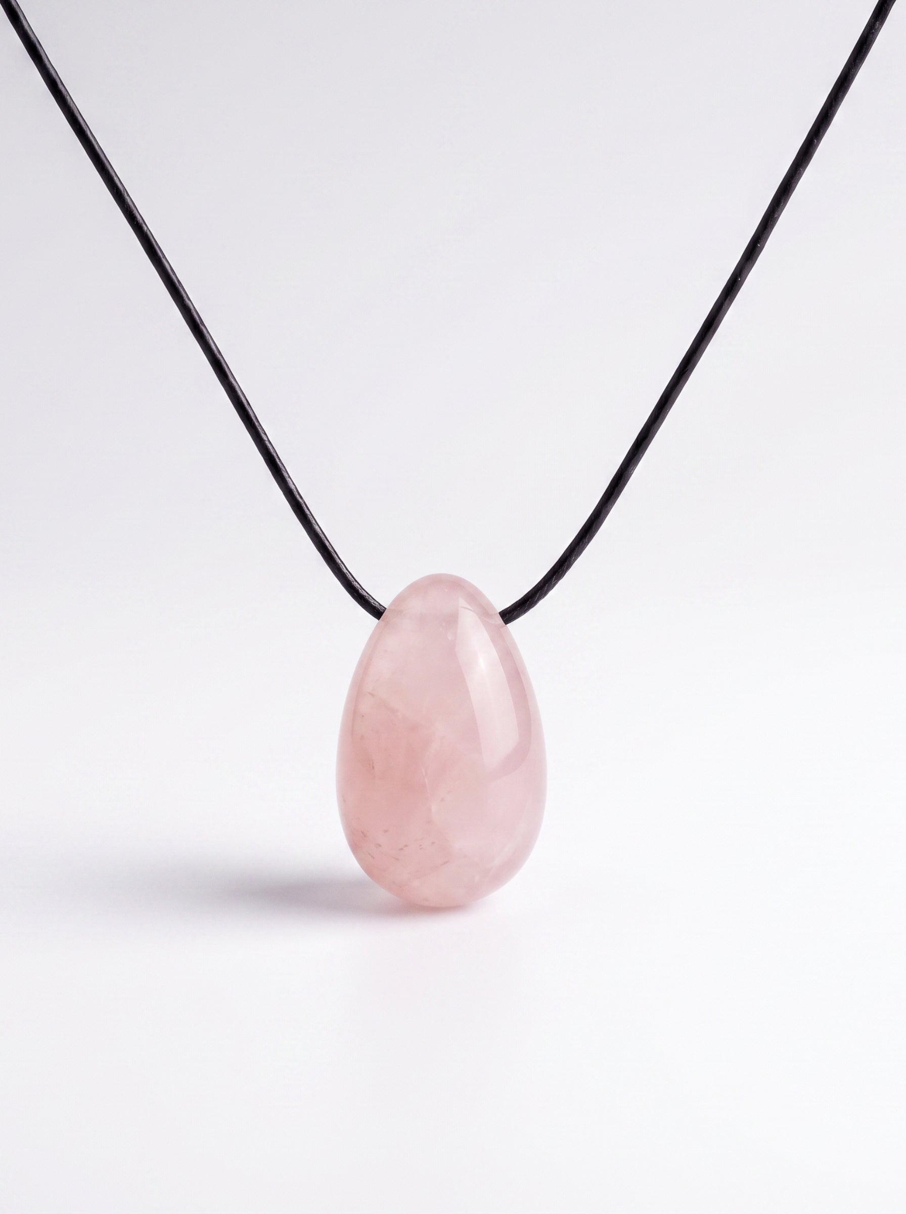 Rose Quartz egg-shaped pendant necklace photographed on a white background