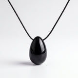 Black Obsidian egg-shaped pendant necklace photographed on a white background