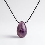 Amethyst egg-shaped pendant necklace photographed on a white background