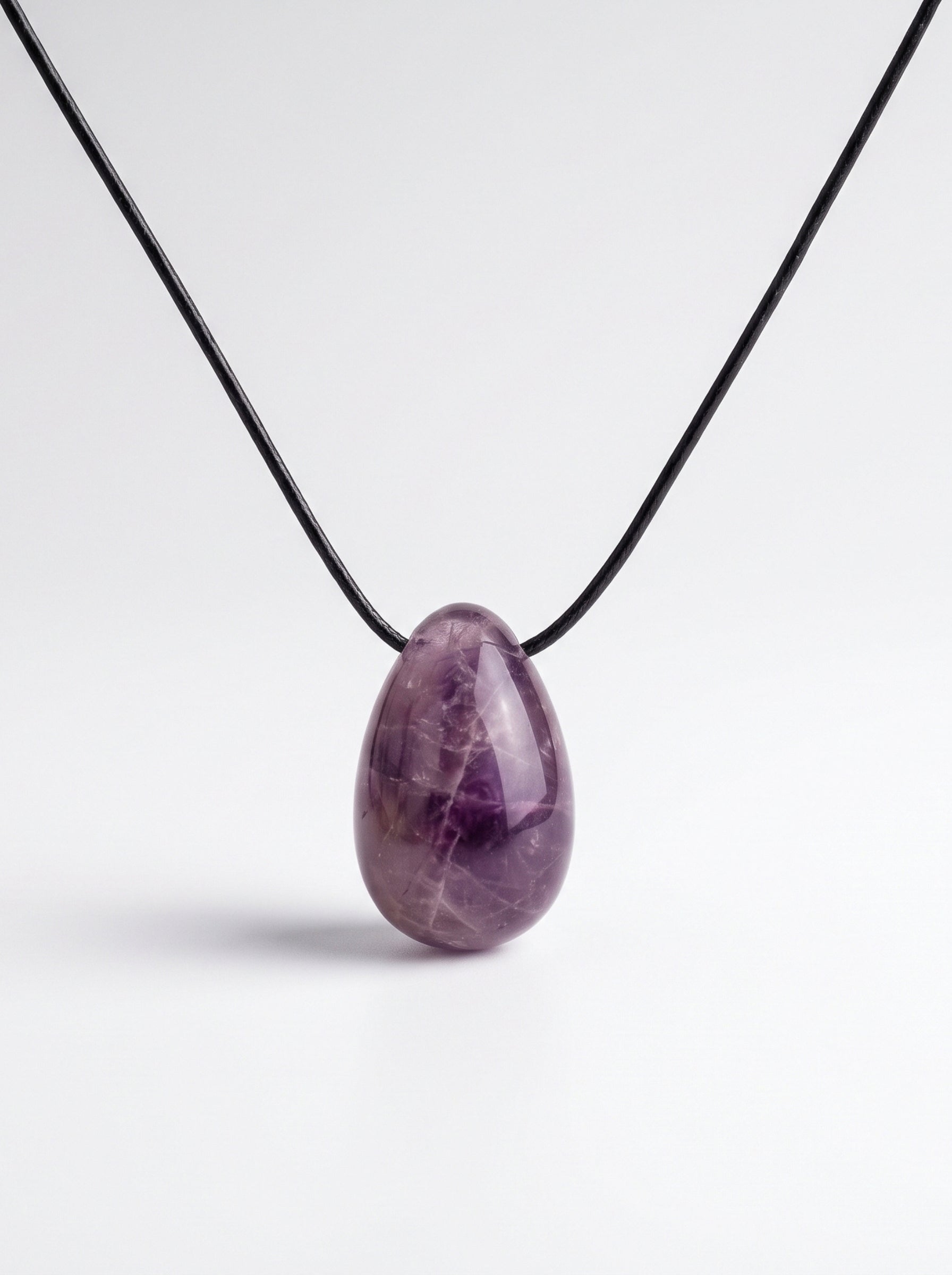 Amethyst egg-shaped pendant necklace photographed on a white background