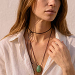 Model wearing Green Aventurine pendant with layered black silk cord styling