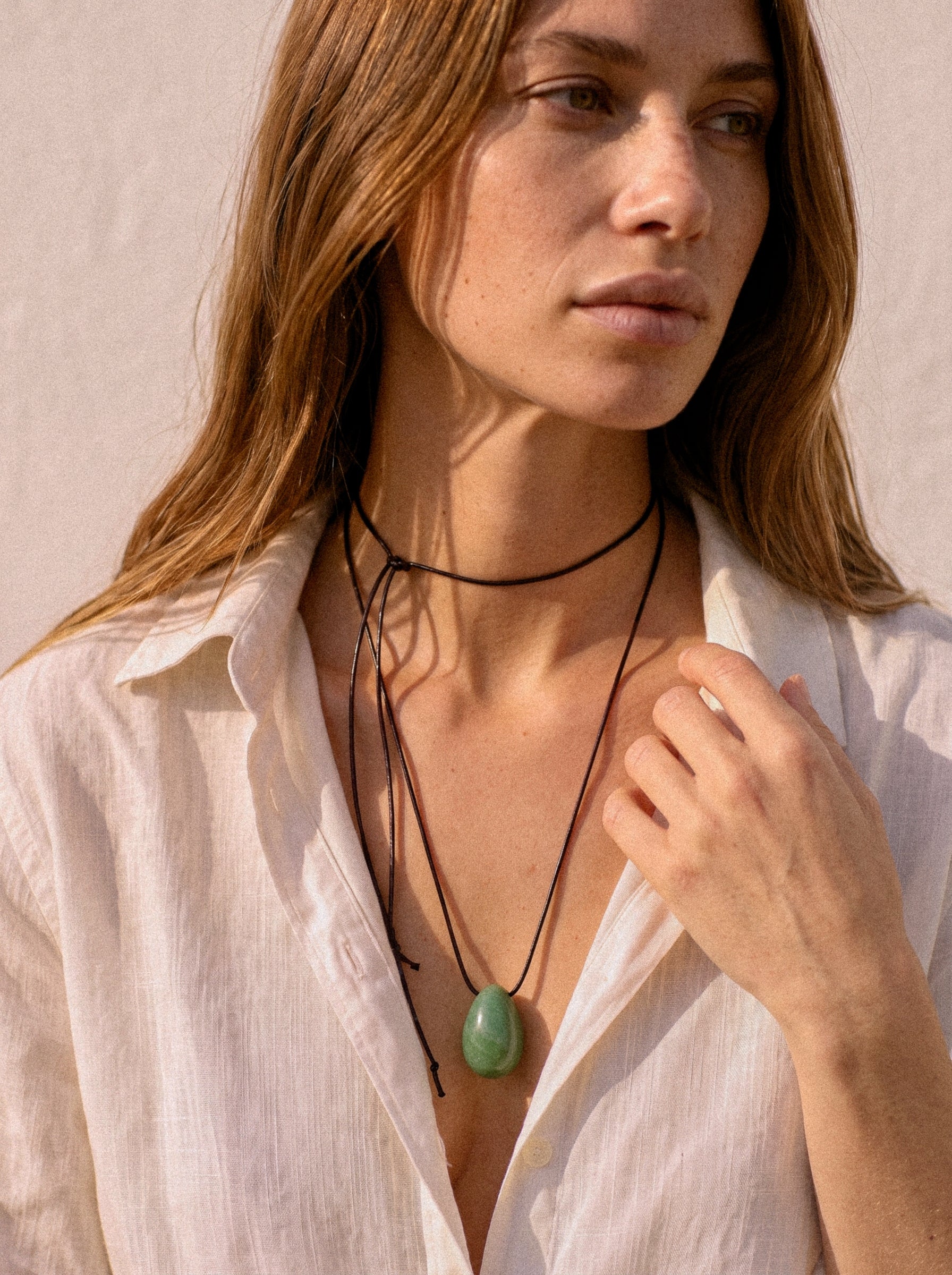 Model wearing Green Aventurine pendant with layered black silk cord styling