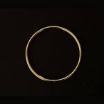 a 18k gold vermeil cuff bracelet with a round shape. The bracelet is made entirely of silver, with a smooth and polished finish. This versatile 18k gold vermeil cuff bracelet adds a touch of elegance and sophistication to any wrist.